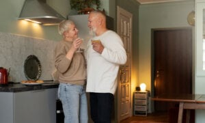 Canadian couple in the kitchen of their cottage as they contemplate selling and if they an avoid taxes.