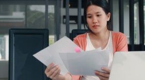 a woman looking over pages