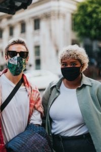 two young people wearing fabric face masks