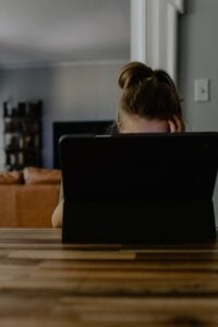 woman behind computer screen