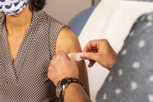 band-aid applied to upper arm following vaccine