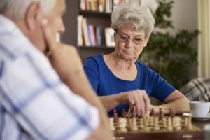 silver-haired couple playing chess