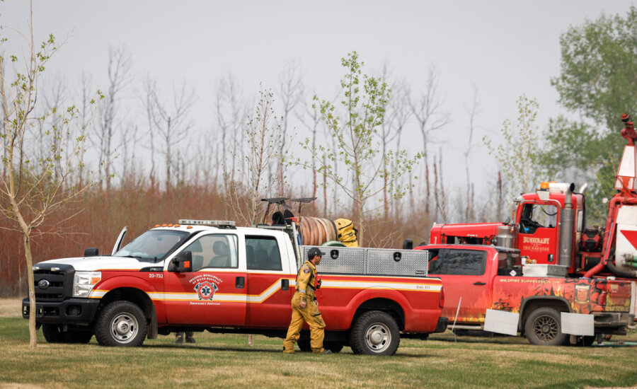 Fire-fighting personnel arrive in the evacuated neighbourhood of Beacon Hill in Fort McMurray, Alta., on Wednesday, May 15, 2024.