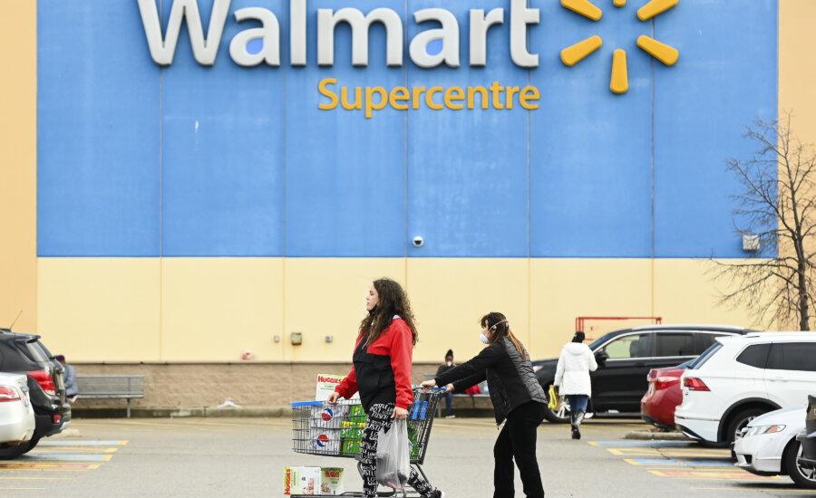 People leave a Walmart store in Mississauga, Ont., Thursday, Nov. 26, 2020.