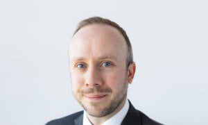 A head shot of David Miller on a white background appears.