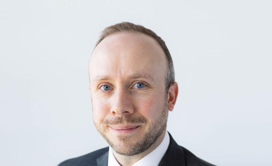 A head shot of David Miller on a white background appears.