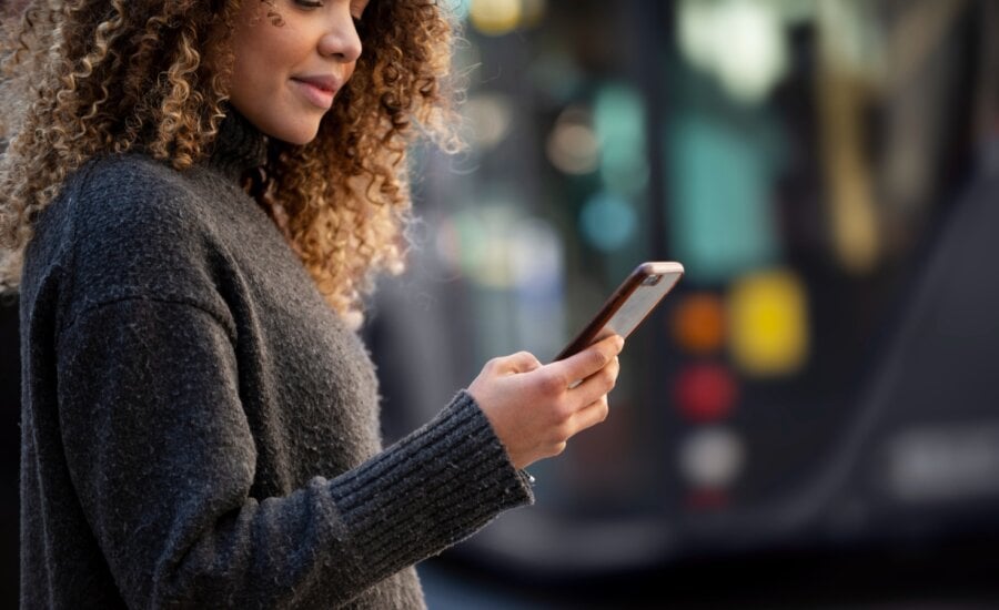 A woman uses a personal finance app on her phone