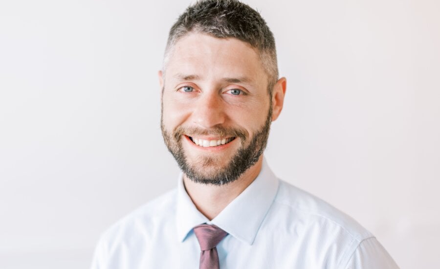 A head shot of Joseph curry on a white background is seen.