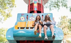 Two girls screaming on an amusement park ride