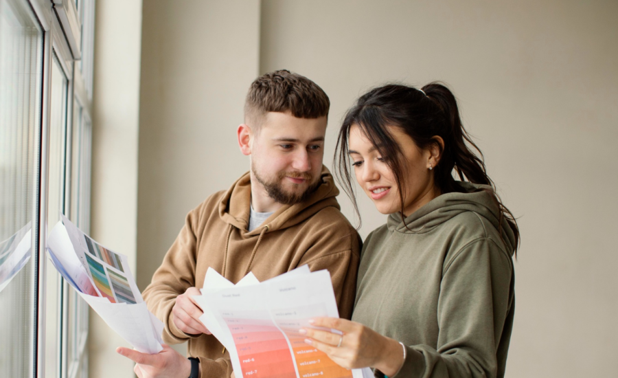 A man and woman consider paint chips in their new condo