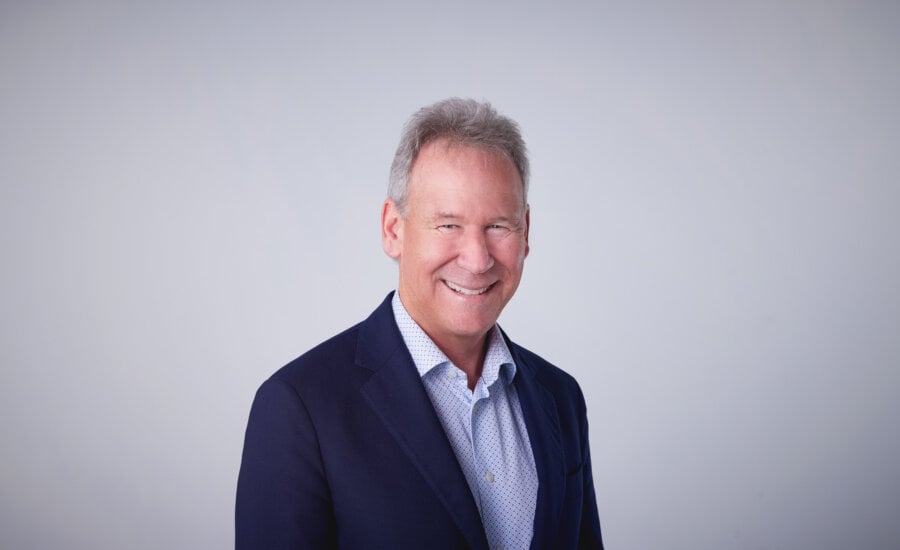 A head shot of Allan Norman on a white background.