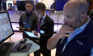 Specialist James Denaro, right, works at his post on the floor of the New York Stock Exchange, Monday, Aug. 5, 2024. Nearly everything on Wall Street is tumbling as fear about a slowing U.S. economy worsens and sets off another sell-off for financial markets around the world.