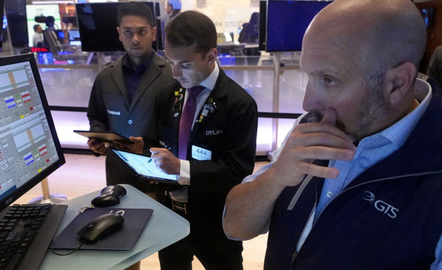 Specialist James Denaro, right, works at his post on the floor of the New York Stock Exchange, Monday, Aug. 5, 2024. Nearly everything on Wall Street is tumbling as fear about a slowing U.S. economy worsens and sets off another sell-off for financial markets around the world.