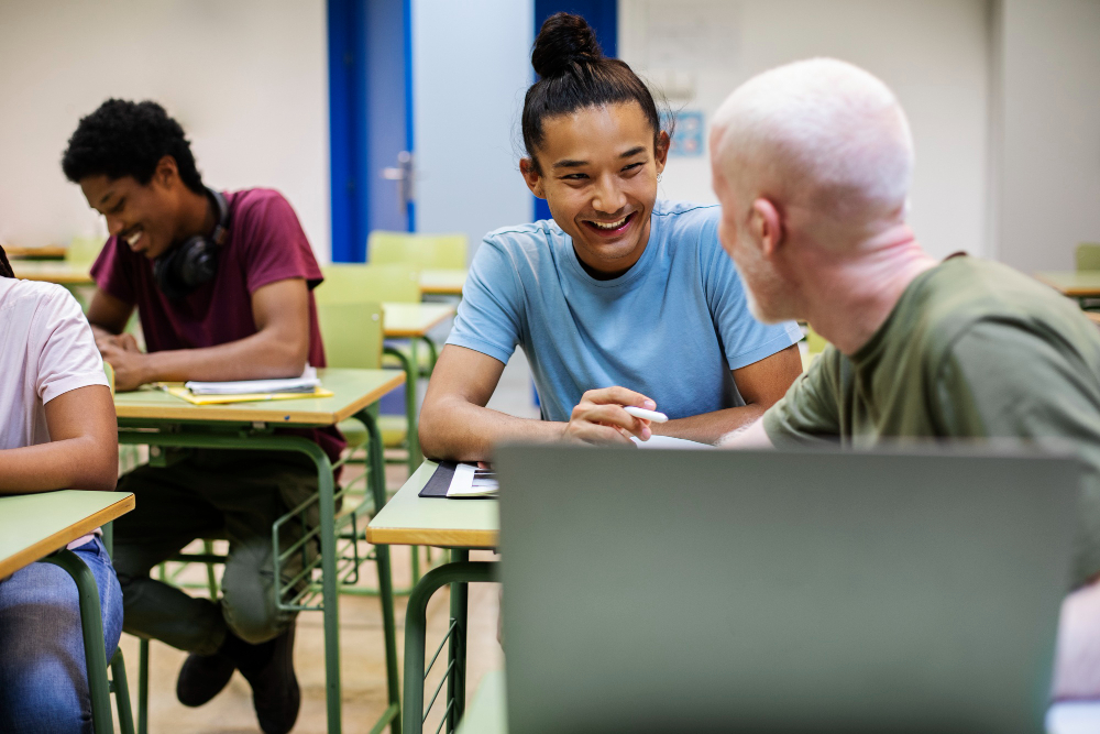 Adult students chat in a classroom