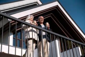 senior couple on balcony of home