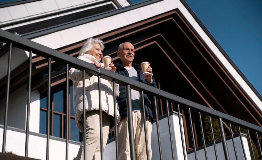 senior couple on balcony of home