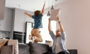 Father and son jump for joy in their new home