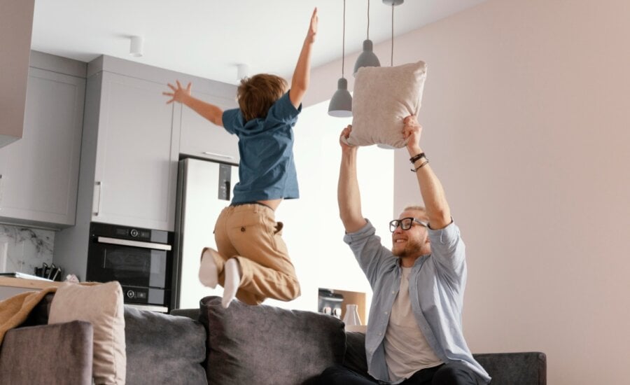 Father and son jump for joy in their new home