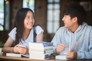 university students at library table