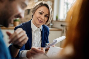 A financial advisor meets with two clients.