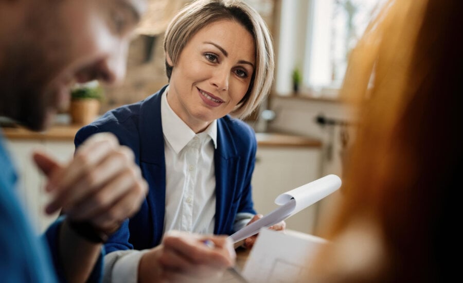 A financial advisor meets with two clients.