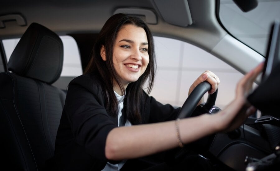 A young rideshare driver prepares to accept an assignment on her phone