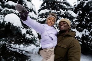 Immigrant father and daughter in snowy forest