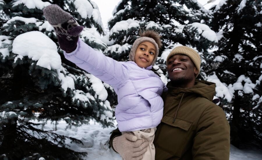 Immigrant father and daughter in snowy forest