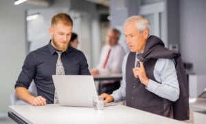 Two Canadian men at work, thinking about retiring and the risks he'll need to manage.