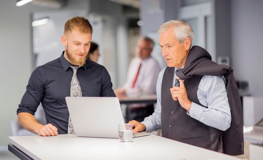 Two Canadian men at work, thinking about retiring and the risks he'll need to manage.