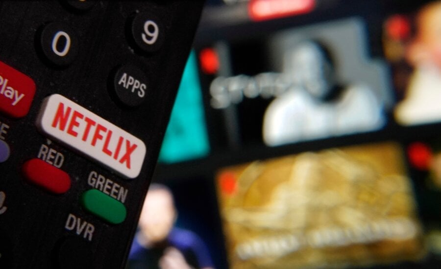 The Netflix button on a television remote control was juxtaposed with a Netflix web page, in this photo in New York, Feb. 2, 2023.