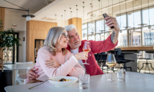 Middle-aged couple taking a selfie at a restaurant