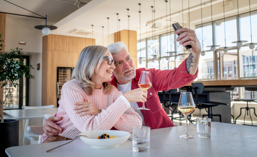 Middle-aged couple taking a selfie at a restaurant