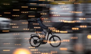 A food delivery worker rides a bike in downtown Vancouver, B.C