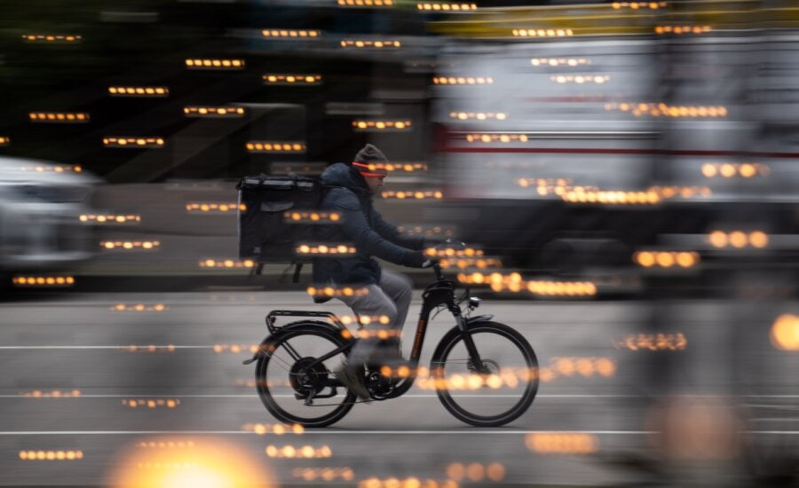 A food delivery worker rides a bike in downtown Vancouver, B.C