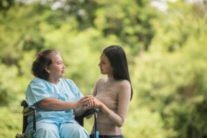 Elderly woman in wheelchair with granddaughter