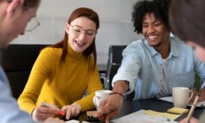 A group of friends sit around a table, planning for the year ahead