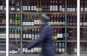 A temporary pause on federal sales tax and sending cheques to millions of Canadians ahead of the holiday season could give a significant boost to consumer spending, an economist says. A person walks past shelves of bottles of alcohol on display at an outlet in Ottawa, Thursday, March 19, 2020. THE CANADIAN PRESS/Adrian Wyld