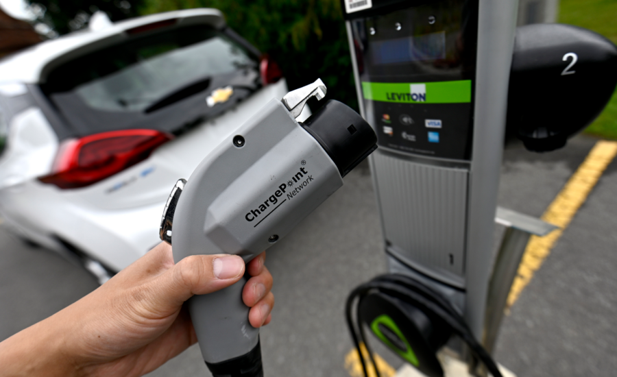 A car parked at an EV charging station