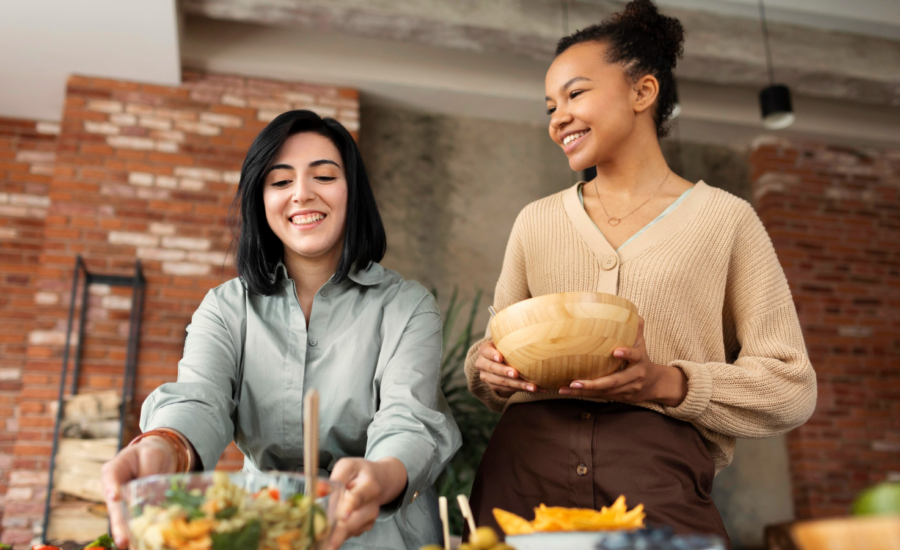 Two young women prepare food for a dinner party