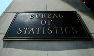 A plaque on a building with the words Bureau of Statistics