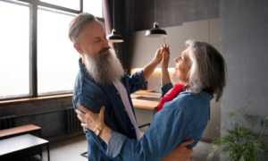 A middle-aged couple dance in their new condo