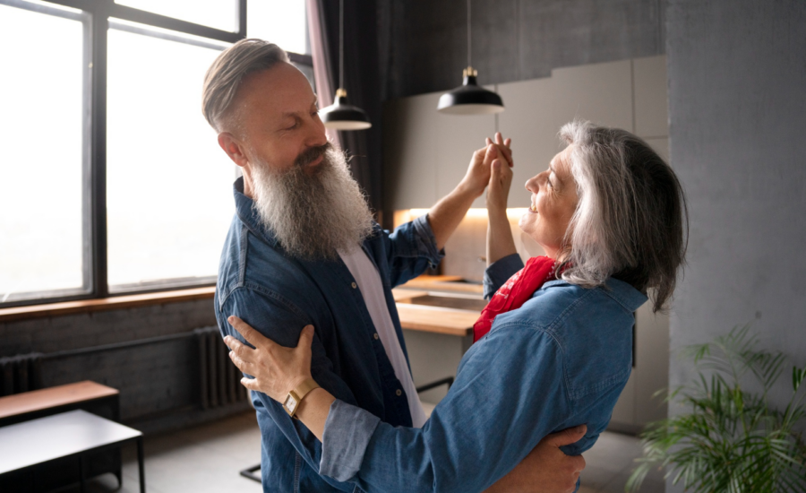 A middle-aged couple dance in their new condo