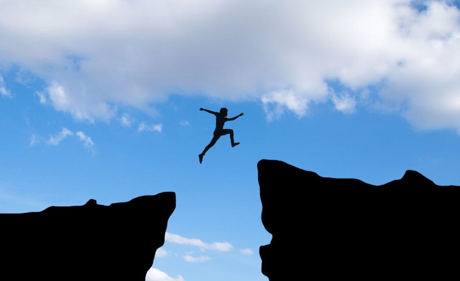 A Canadian jumping over gap, to symbolize managing risks in a portfolio with ETFs.