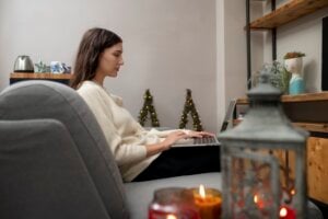 woman works on laptop December indoor scene