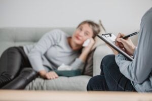 woman lies on psychiatrist's couch