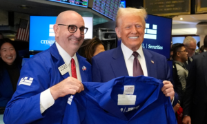 Donald Trump is given a jacket by trader Peter Giacchi at the New York Stock Exchange,