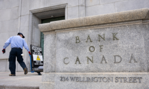 A maintenance worker outside the Bank of Canada building on Wellington Street in Toronto