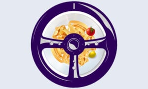 A car steering wheel and a bowl of pasta, as symbols of how to get the best auto loan interest rate.