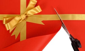 Photo of a holiday gift cut with scissors—symbolizing a December Bank of Canada rate cut.